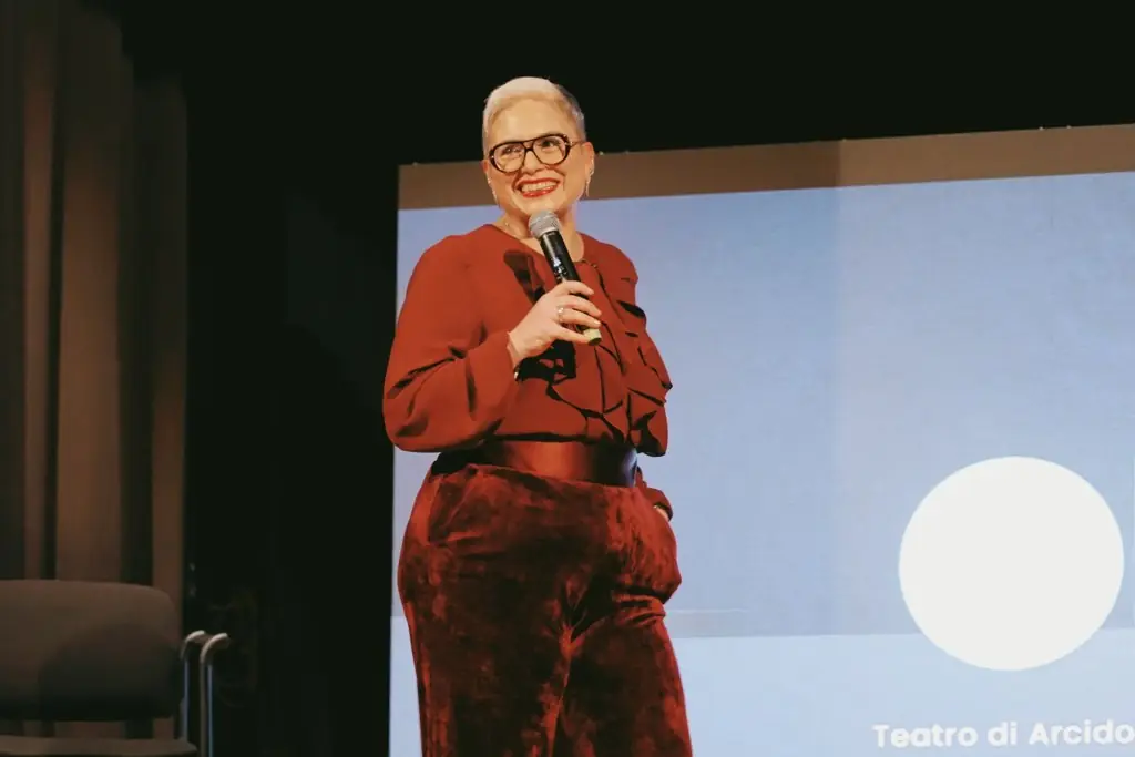 Alessandra Salimbene on a theatre stage during a training day for the staff of an optical group